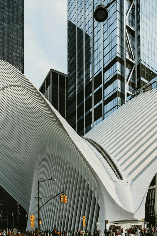 some people walking near large white buildings