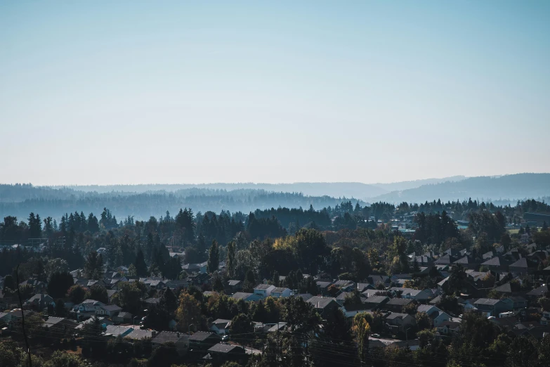 the hills are tall and in the distance are houses