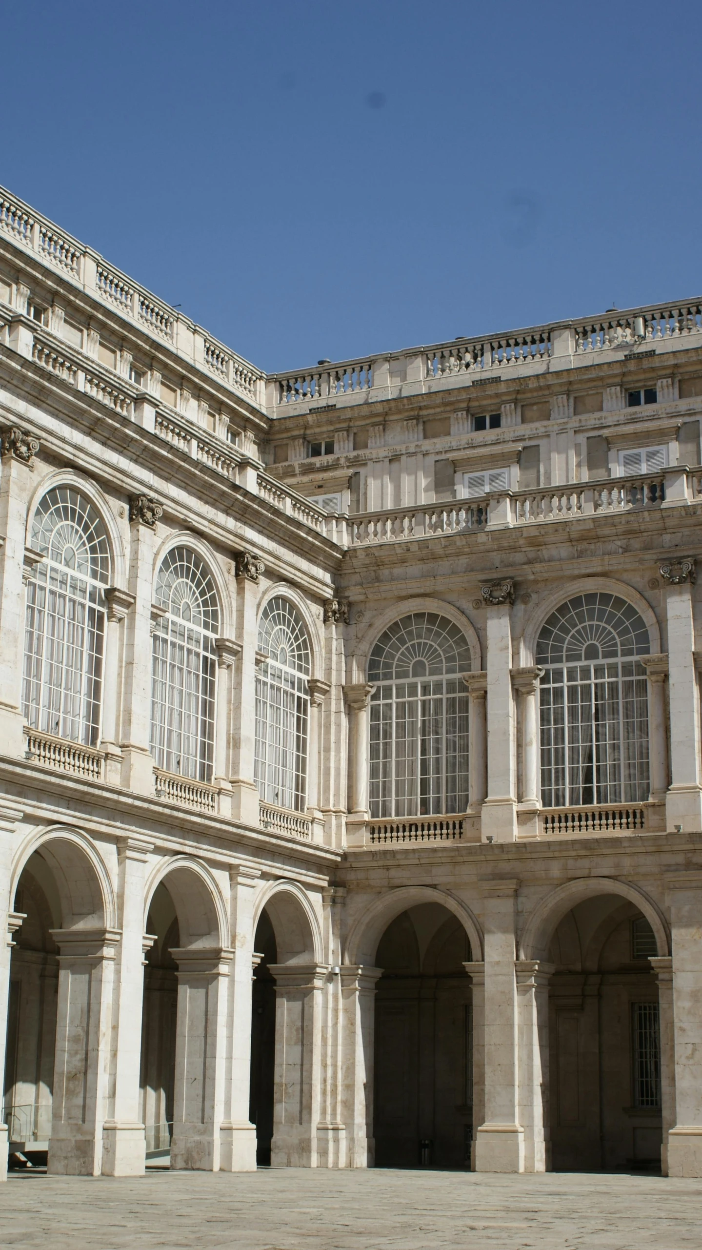 a stone building with several circular windows and arched archways