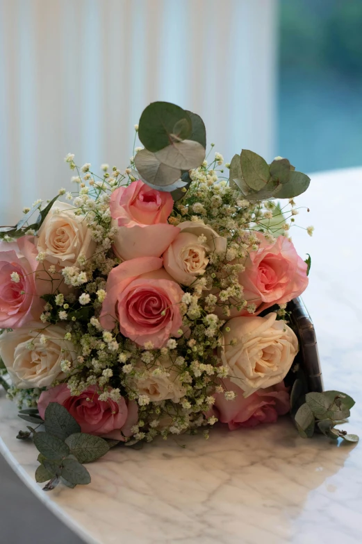 a bouquet with lots of white and pink flowers