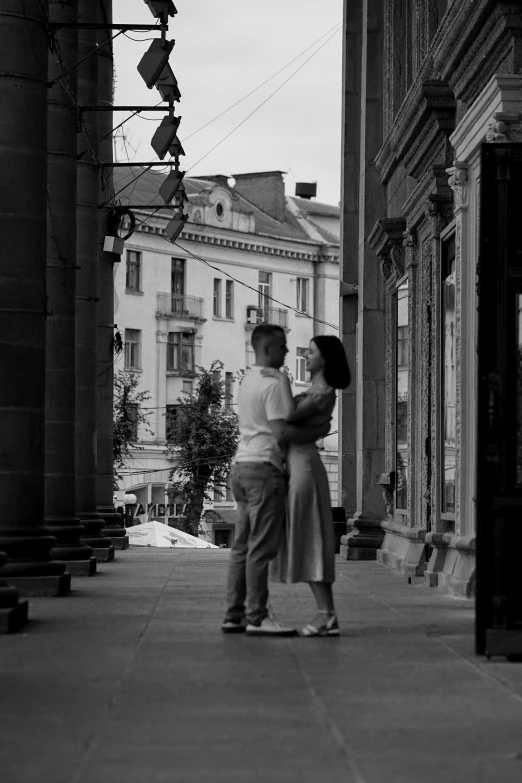 the couple are emcing under a traffic light on the street