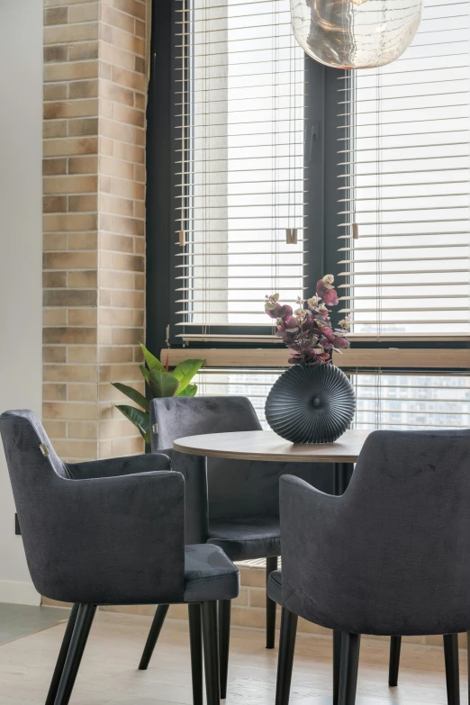 the two black vases are on a table