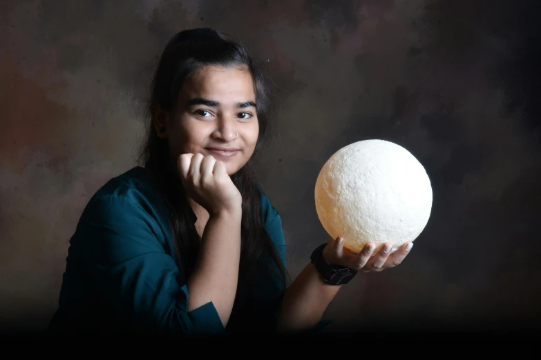 a woman is holding a white object while posing for a po