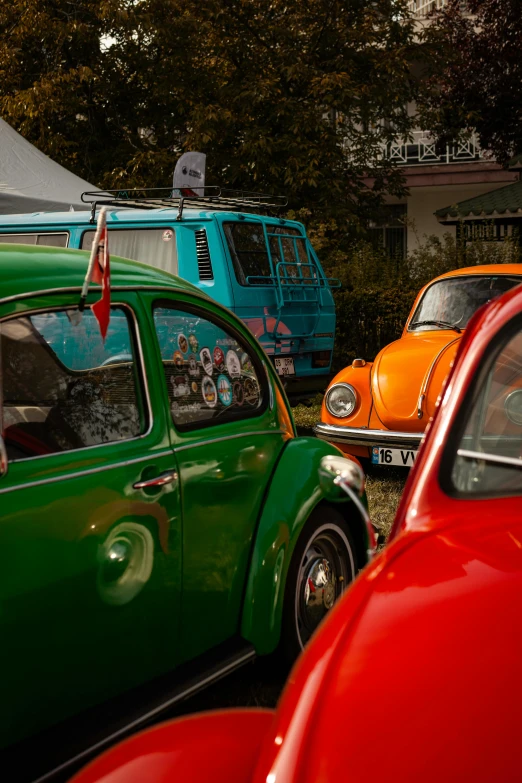 three colored cars on a street and one is in between