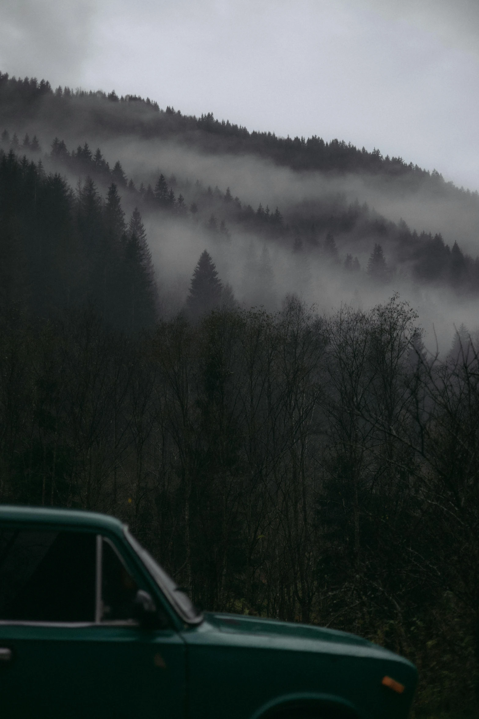 a car parked in front of a hill