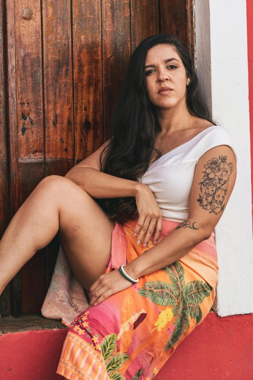 the woman is posing in front of a wooden wall