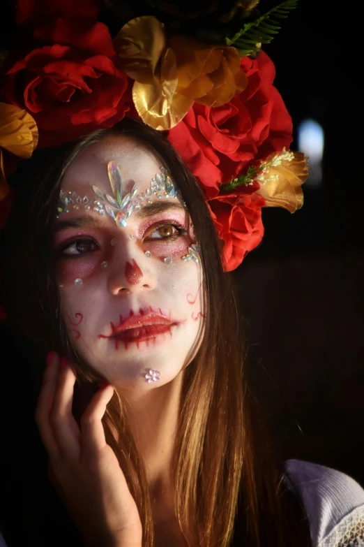 a young woman with makeup painted white and red