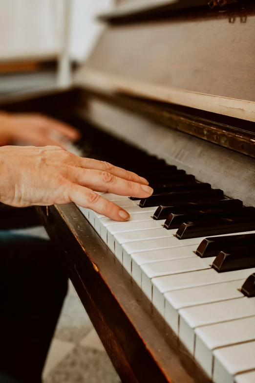 a person playing on a white and black piano