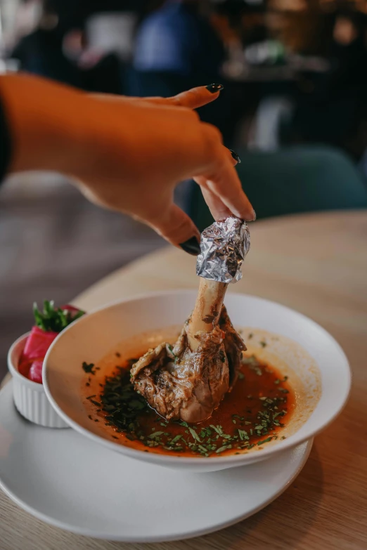 a person taking some food out of a bowl