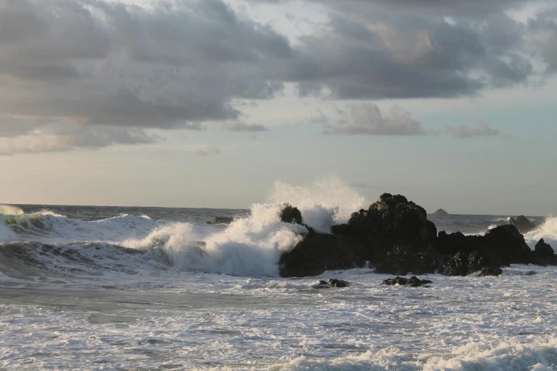 a couple of rocks are in the water