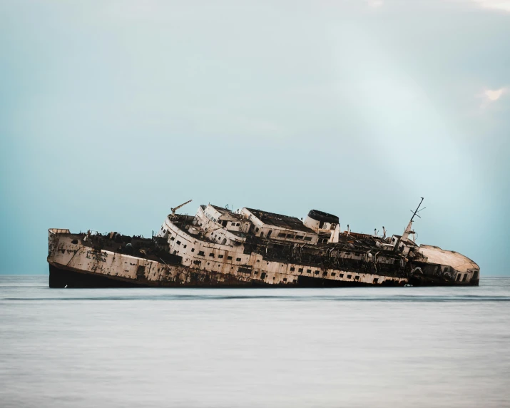 a boat is sinking off of the water