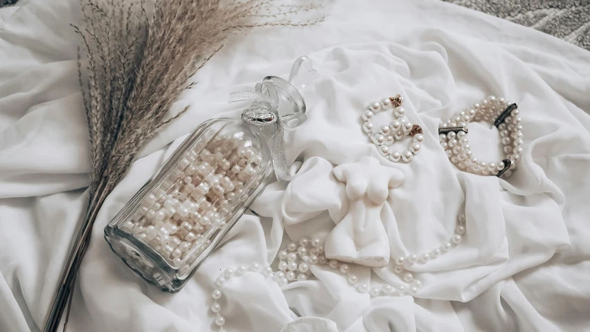 the white sheets are covered with beads and accessories