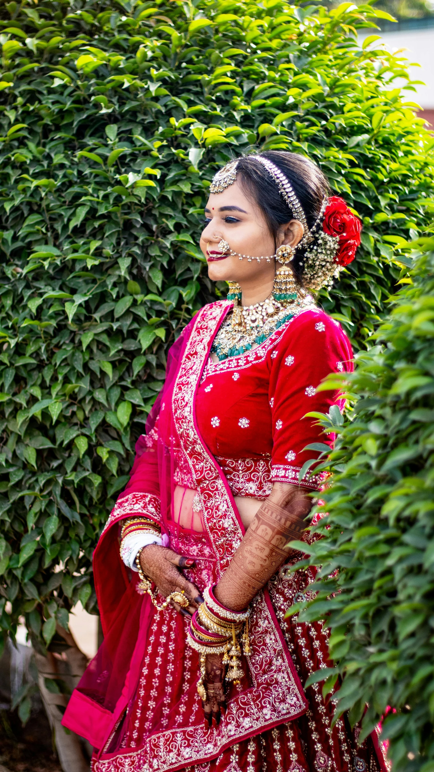 a woman wearing a red outfit and red flower in her hair