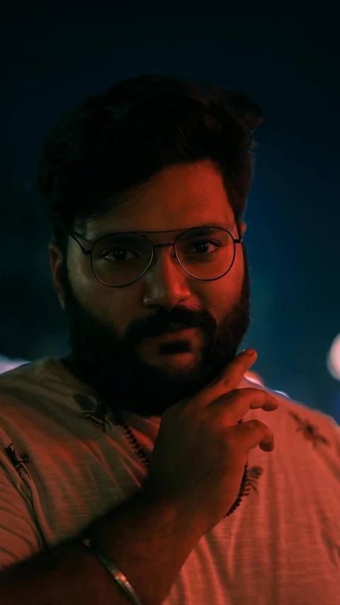 man with a beard wearing glasses and red shirt