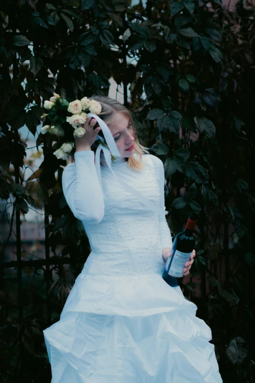 there is a bride that is holding a wine bottle