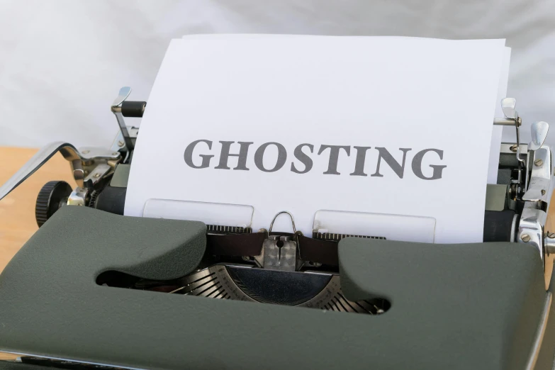 a closeup of a typing machine that says ghosting