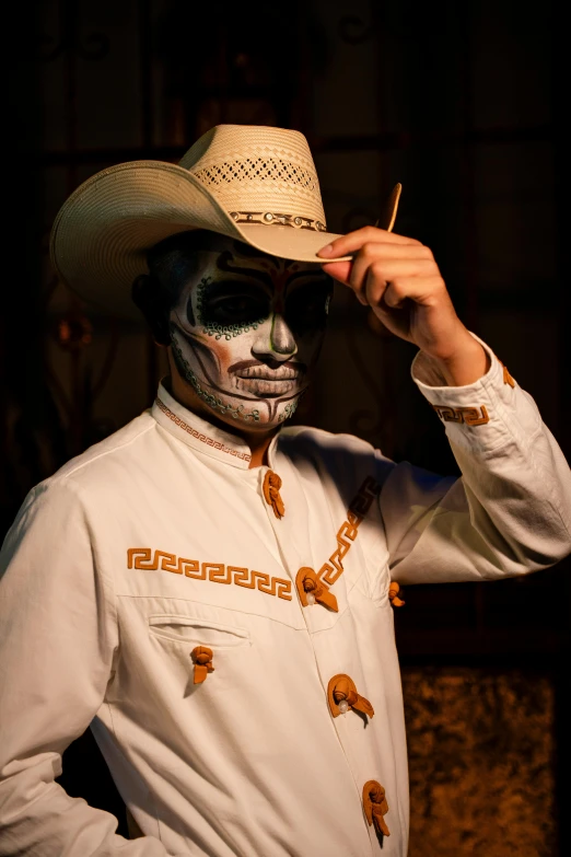 a skeleton painted in yellow and white with a straw hat