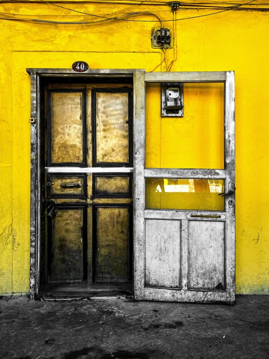 an open door and window on the outside of a yellow building