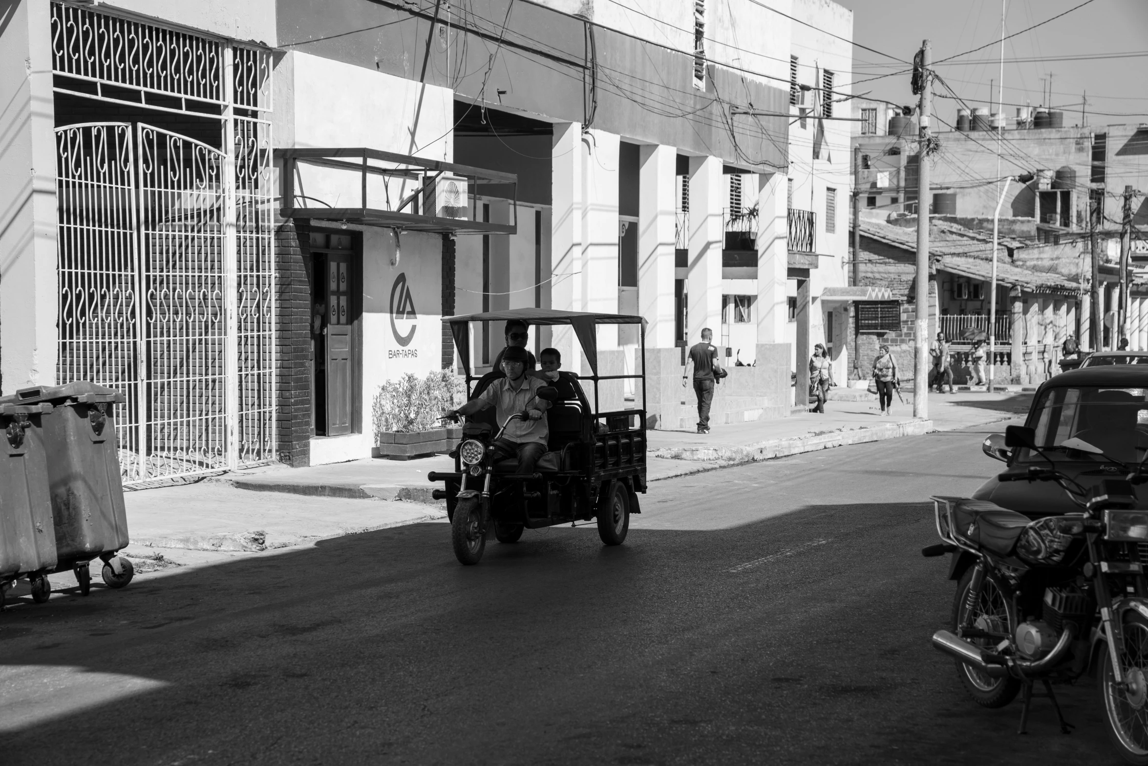 two people on a motorcycle in the middle of a city