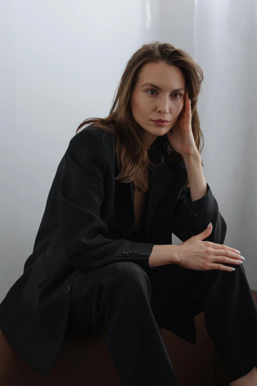 a woman sitting in a chair posing for a picture