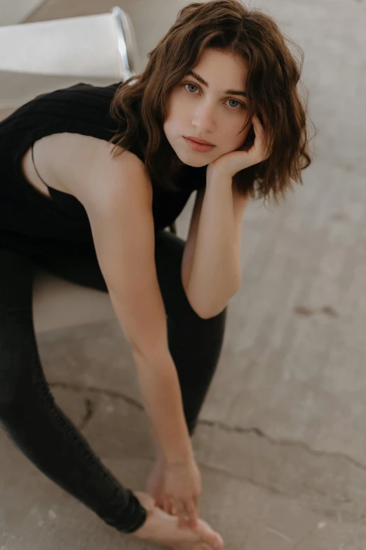 a woman posing for a portrait next to stairs