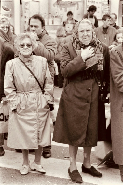 a couple of elderly women standing by a train