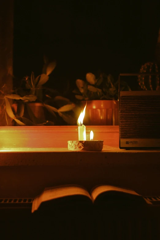 a candle that is lit up in the dark