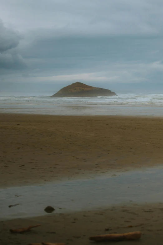 a man walking with a surfboard on the beach