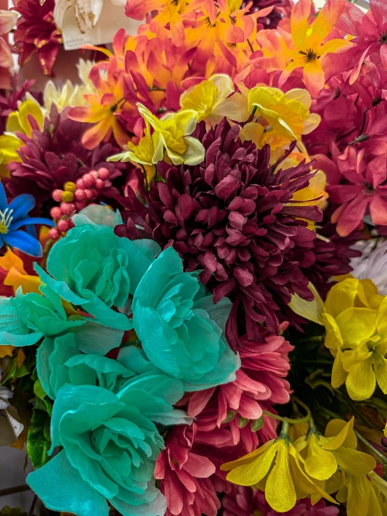 a bouquet of colorful flowers displayed in a vase