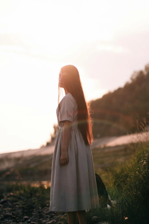 a woman with long hair wearing a white dress