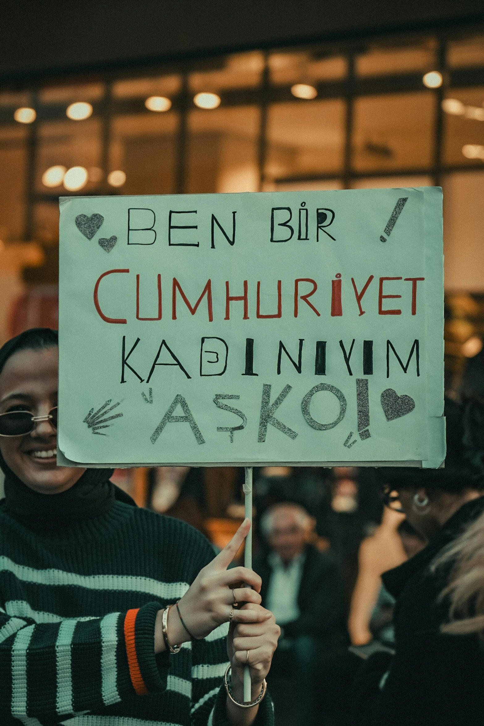 woman holding a white sign in the street