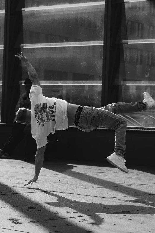 a person doing a handstand on the sidewalk