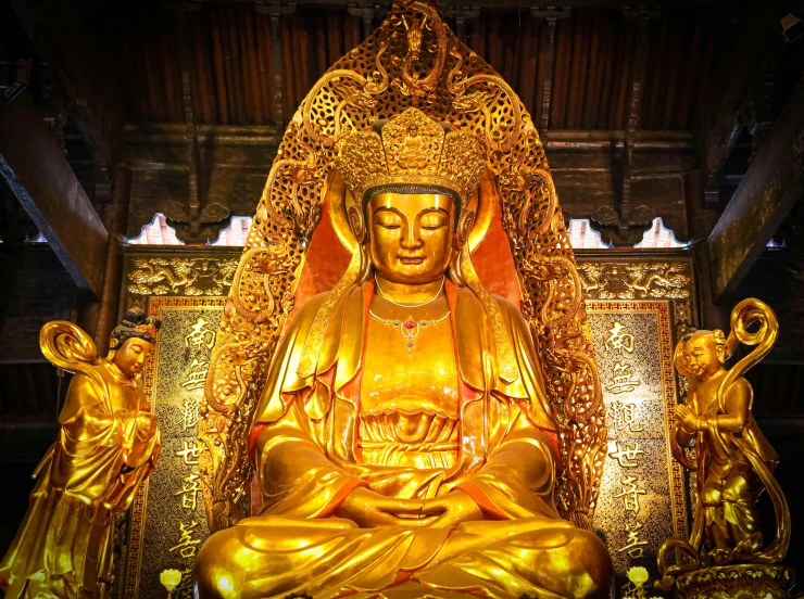 a golden buddha statue sits in an ornate building
