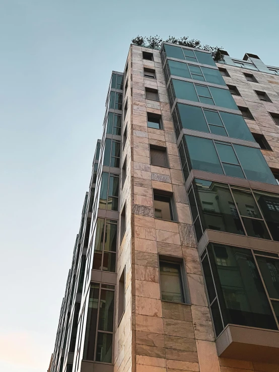 a tall brick building with lots of windows and bars on each floor