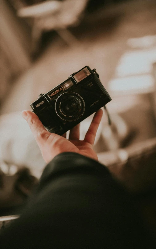 a person holding up a camera in their hands