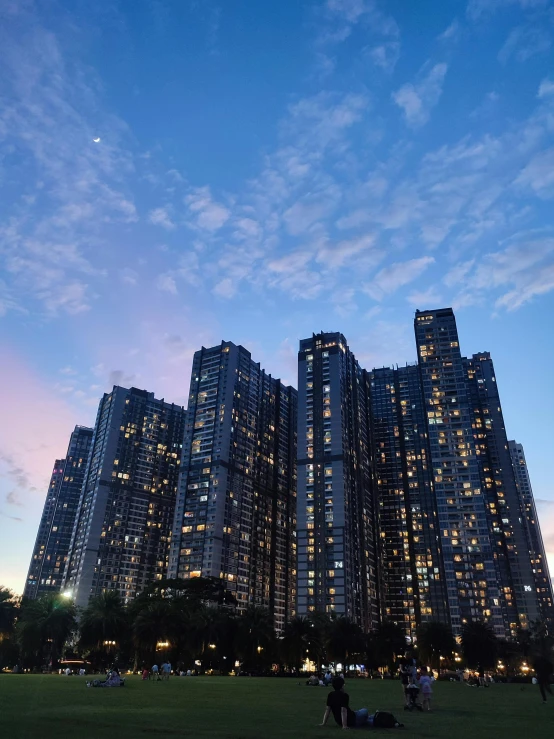 the skyline at night is lit up in front of some tall buildings