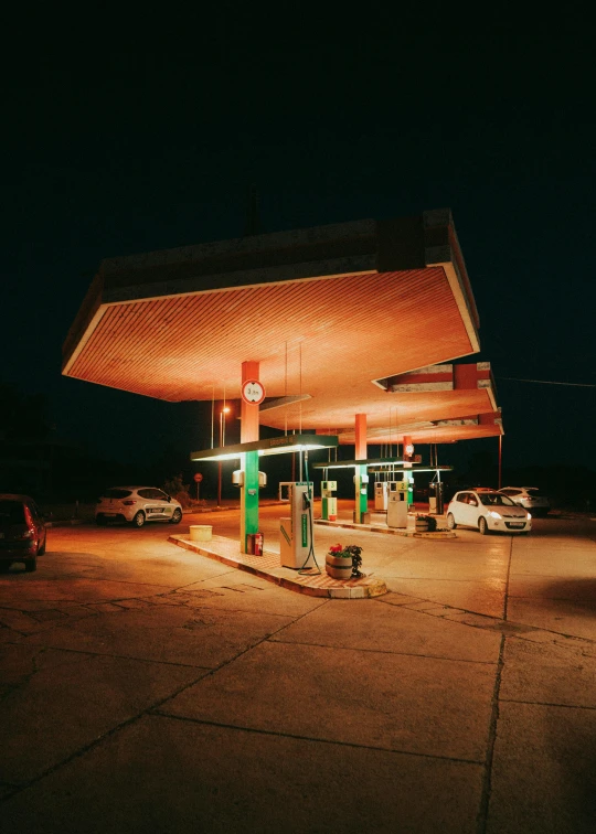 a gas station at night with lights on the side