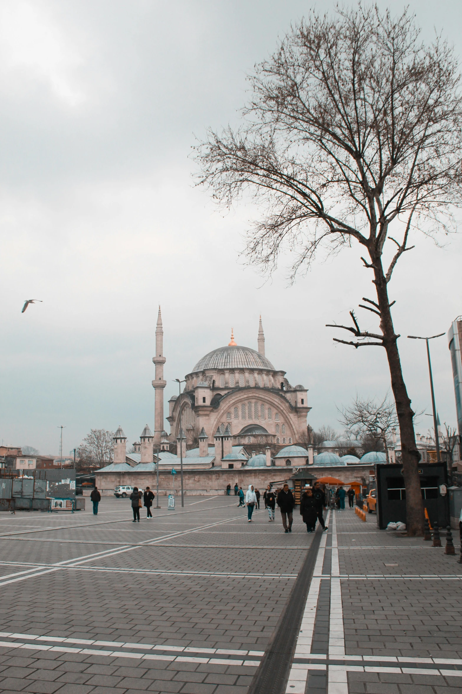 the large building with a dome on top is set up as people walk