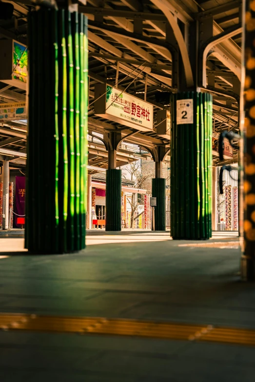 a train station with a few large columns