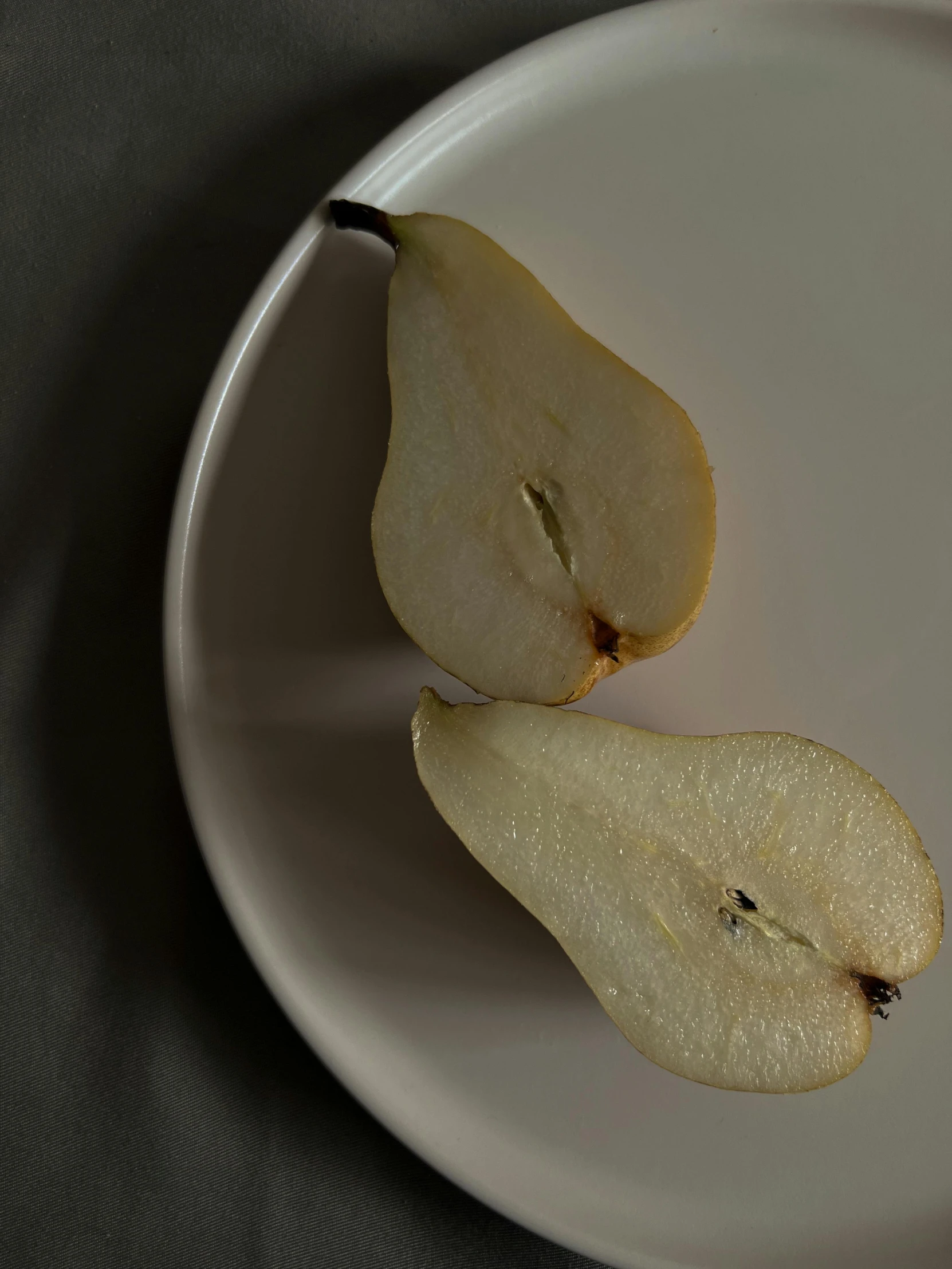 a plate of two slices of apple and one slice open