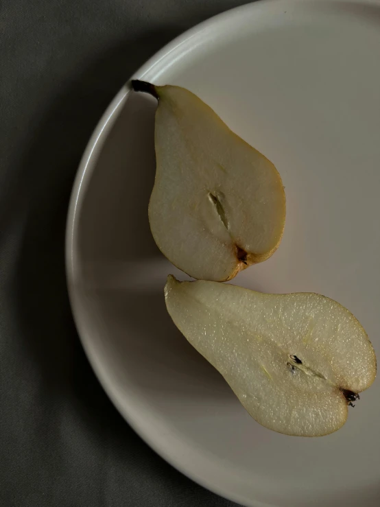 a plate of two slices of apple and one slice open