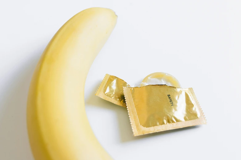 a banana and a condom pouch with foil on it