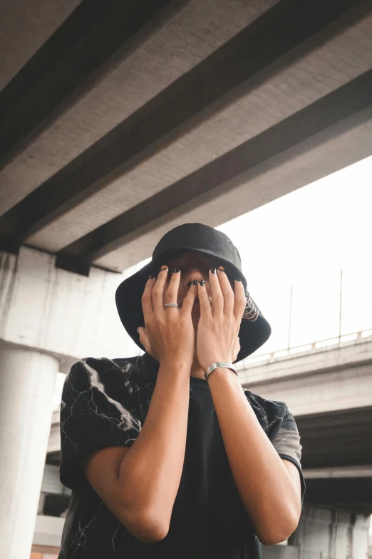 a man holding his hands near his face covering his eyes