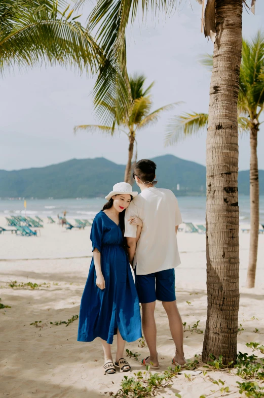 a couple looking at each other on the beach