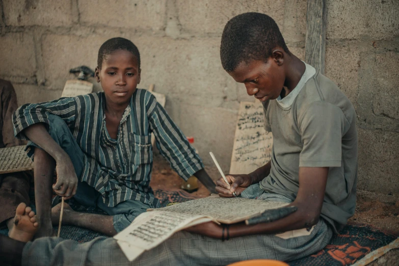 a young man and a woman with some writing on paper