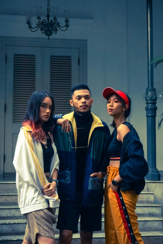 three young people posing for a picture outside