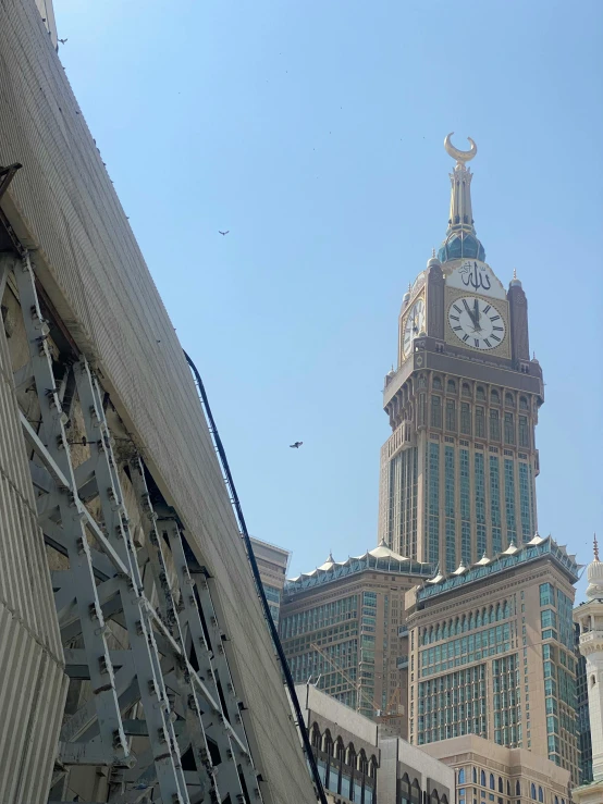 a clock tower stands high above a building in the city