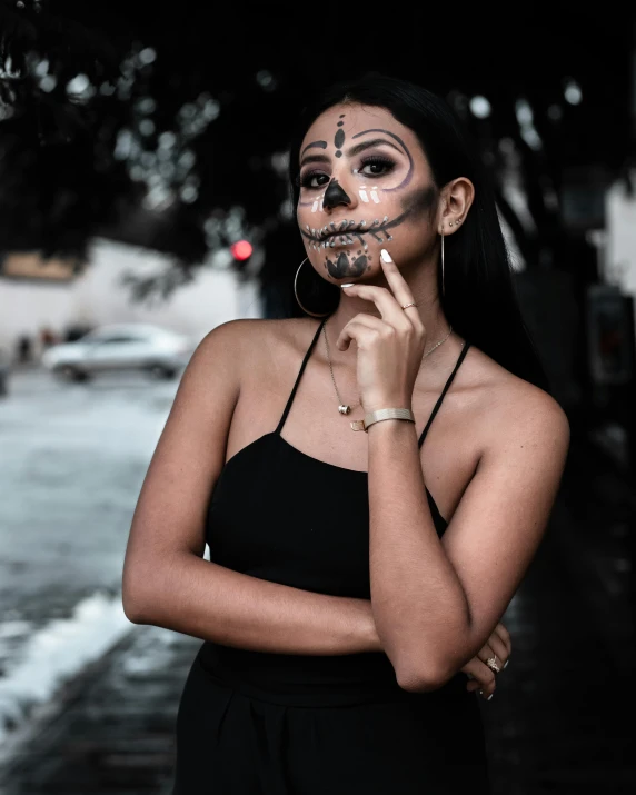 a woman with makeup painted on standing in front of the camera