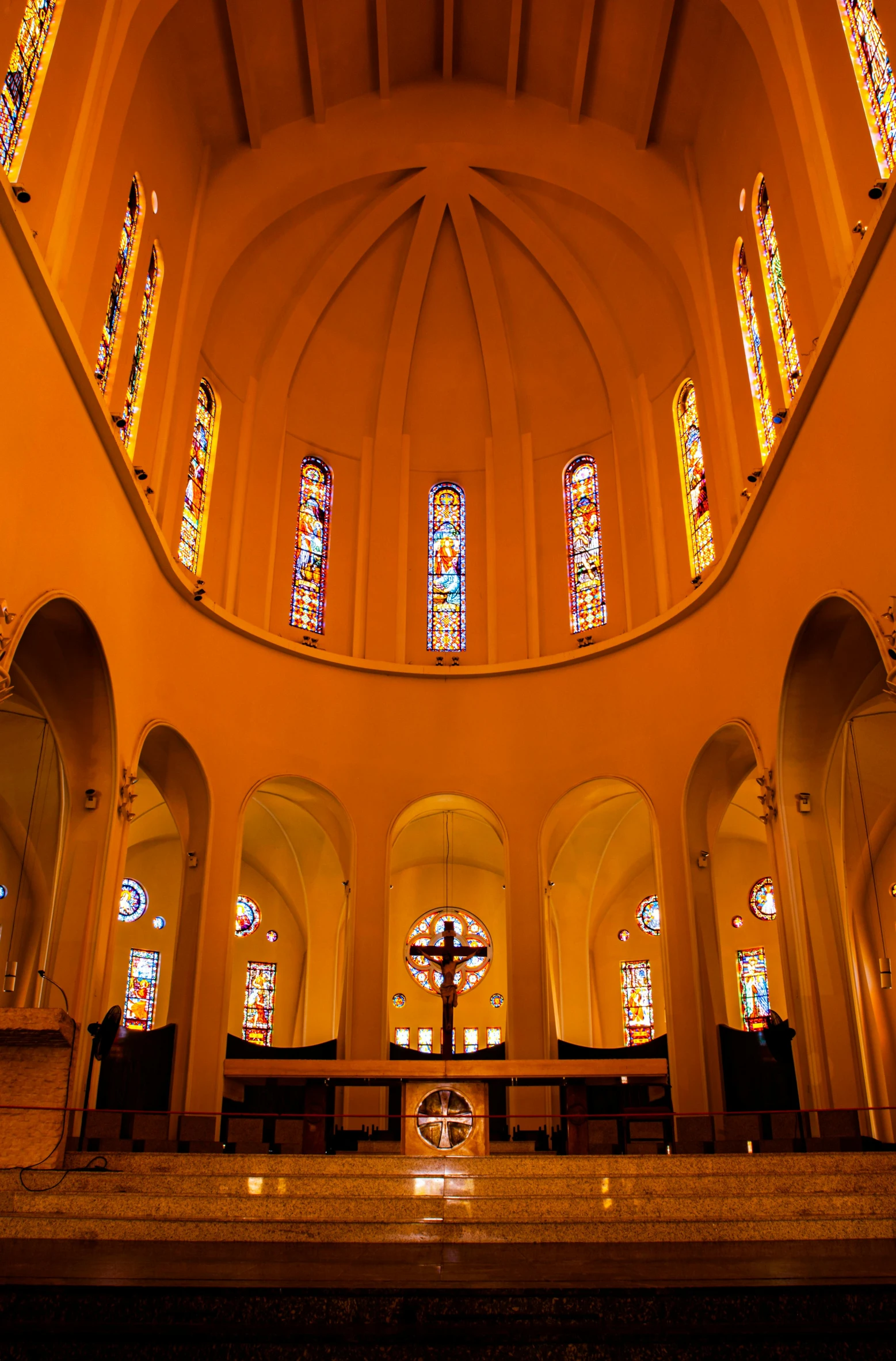 a cathedral is lit by stained glass windows