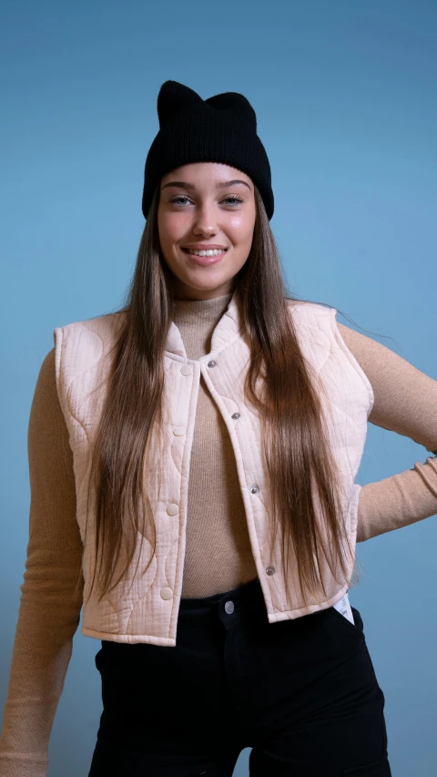 a smiling woman with long hair in a cardigan